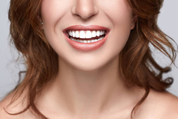 close-up shot of a woman's mouth smiling widely 